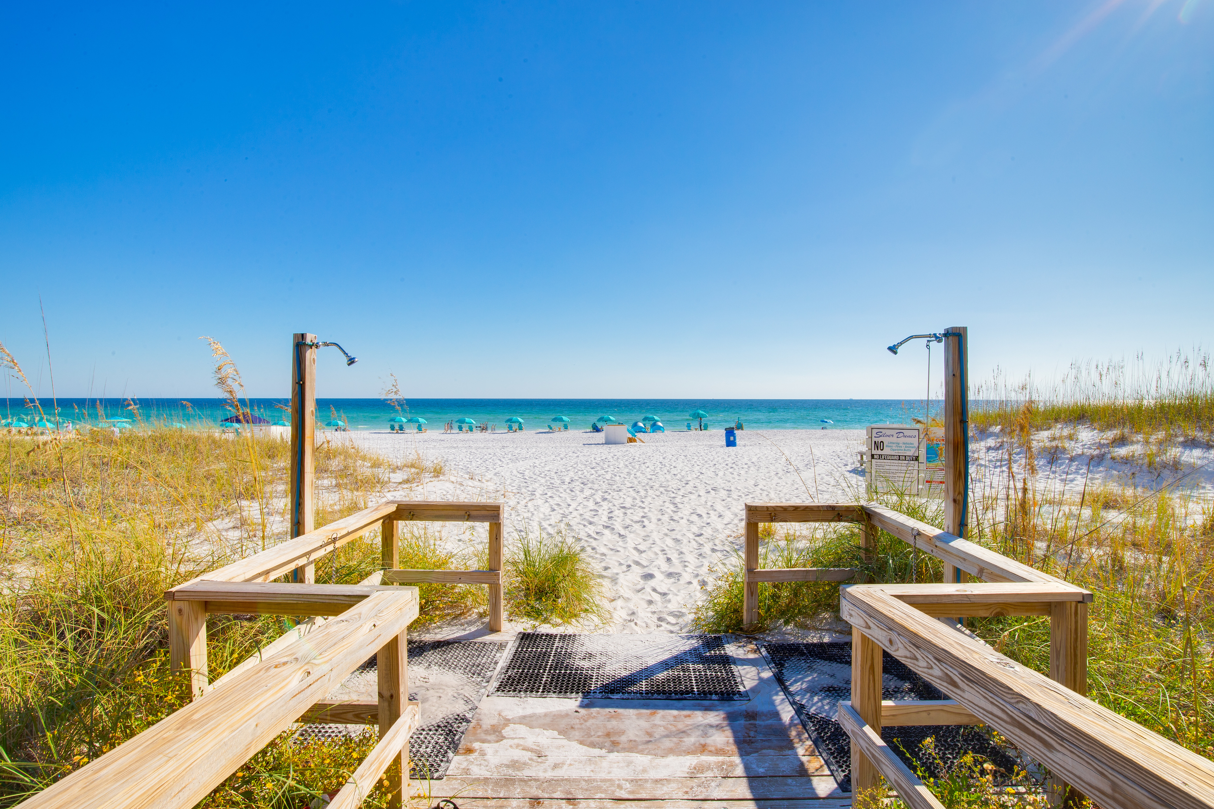 The beach access at Silver Dunes Condominium in Destin, FL on a bright blue sky day.